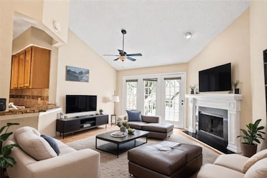 Living room with high vaulted ceiling, ceiling fan