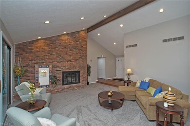 Vaulted great room with full wall fireplace.