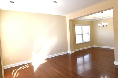 Spare room with a chandelier, crown molding, dark 