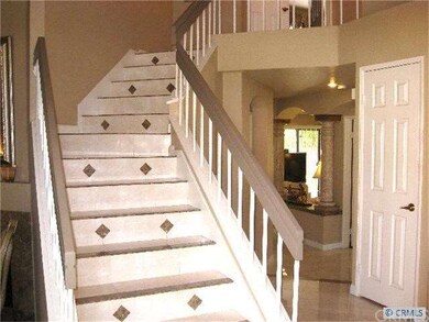 Staircase also features porcelain tile with marble