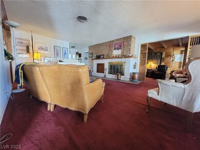 Living room with wood-burning fireplace.