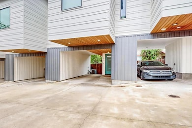 Garage with a carport and driveway