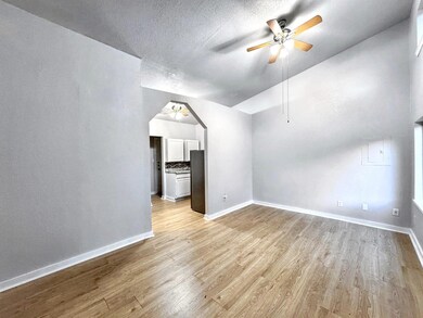 Unfurnished living room featuring light wood fini