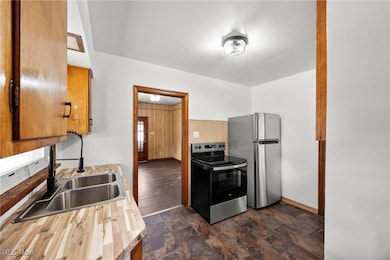 Kitchen featuring appliances with stainless steel finishes and stone finish flooring