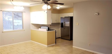 Kitchen with stainless steel refrigerator with ic