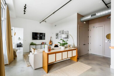 Living room with concrete flooring and rail light