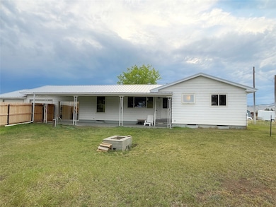 Rear view of property featuring a metal roof