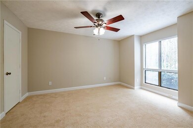 Unfurnished room featuring light carpet, baseboard
