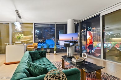 Tiled living area featuring a wall of windows