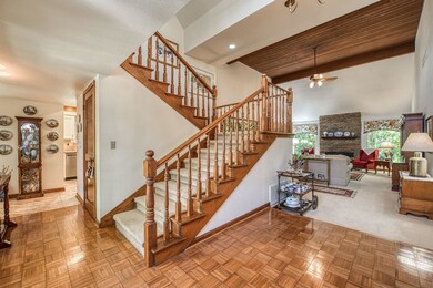 Parquet wood floor entry and elegant staircase.  S
