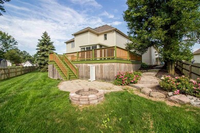 Fenced yard with large deck.