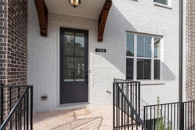 View of exterior entry featuring brick siding and 