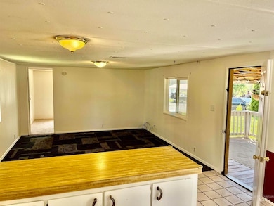 Kitchen featuring healthy amount of natural light, white cabinets, and light countertops
