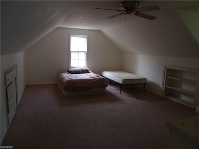 Large upstairs bedroom features built-in dressers and bookshelves in this part of the room.