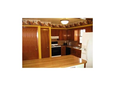 Kitchen with open counter, refrigerator and stove 