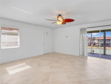 Tiled living room with ceiling fan and a healthy a