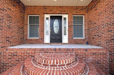 Property entrance featuring brick siding