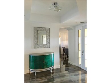 Entry foyer with custom fluted glass entry door and Dale Tiffany blown glass plate lighting.