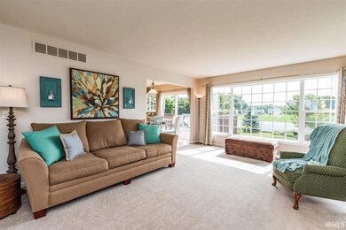 Great Room window wall showcases park-like yard an