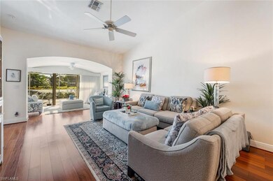 Living room with visible vents, arched walkways, w