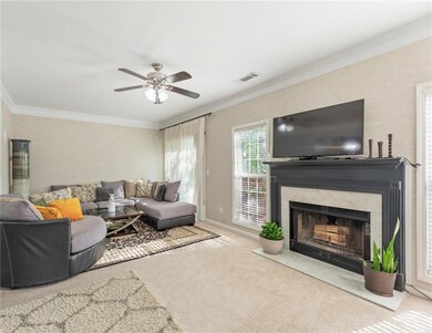 Living room with a high end fireplace, carpet, vis