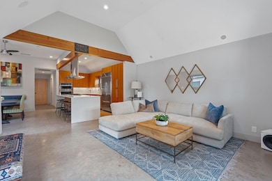 Living room featuring finished concrete floors, a