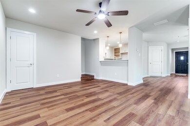 Unfurnished living room featuring baseboards, rece