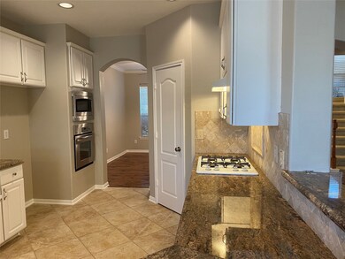 Your dining room is seen through the arched opening. The fridge goes beside the oven and microwave.