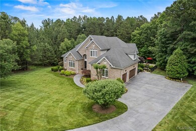 View of front of house with a garage and a front lawn