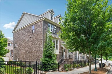 View of home's exterior with brick siding and a fenced front yard