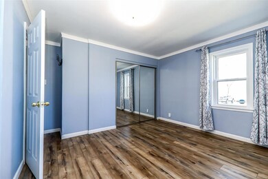 Main floor master bedroom with newer windows and flooring.
