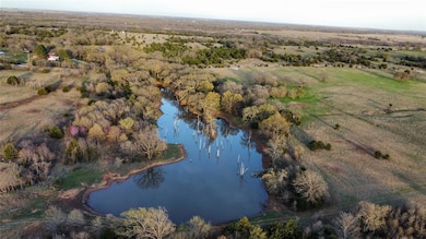 Birds eye view of property with a water view and a