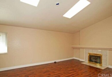 Living room has vaulted ceiling with 2 large skyli