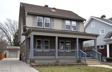 View of front of home with a garage and a porch