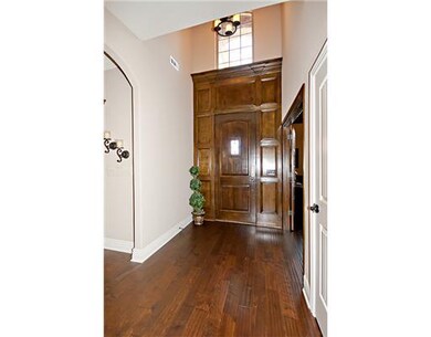 Interior Space/Layout. Two-story entry with floor-to-ceiling woodwork.  Front door security camera