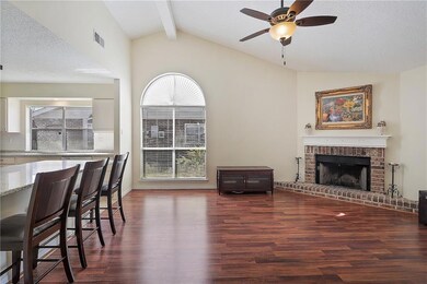 View of Breakfast Bar and Den with gas Fireplace.