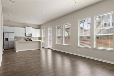 Kitchen with stainless steel appliances, open flo
