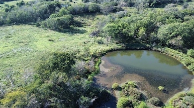 Aerial overview of property's location featuring a nearby body of water