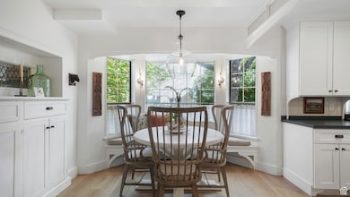 Dining area featuring light wood-style flooring and baseboards