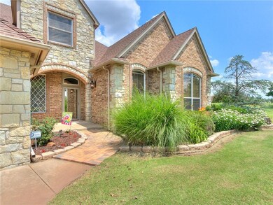 Entryway is landscaped, and has a brick walkway.
