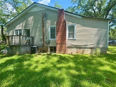 View of home's exterior with a yard, crawl space, and a deck
