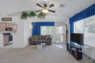Living area featuring light colored carpet, lofted