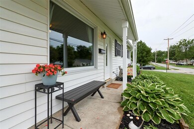 Great covered porch and pretty front door with a l
