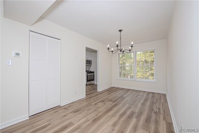 Dining room featuring a notable chandelier and LVP