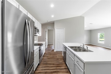 Kitchen with dark hardwood / wood-style flooring,