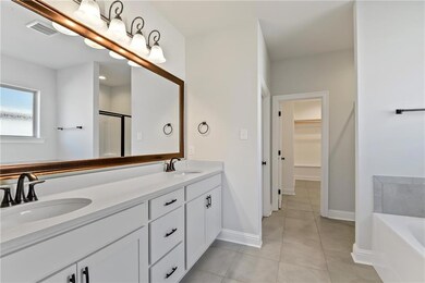 Primary Bathroom with Walk-In Closet in the background.