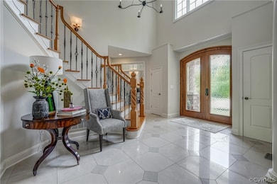 Grand 2-story entrance with gleaming porcelain flo