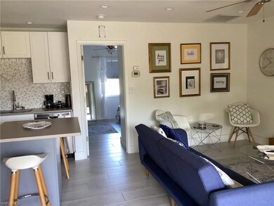 Living room with wood-type flooring and sink