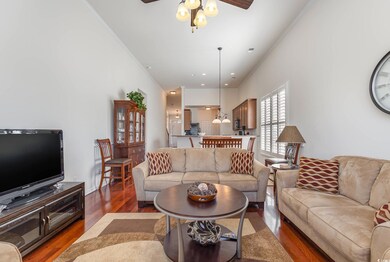 Living room featuring ceiling fan, wood-type floor