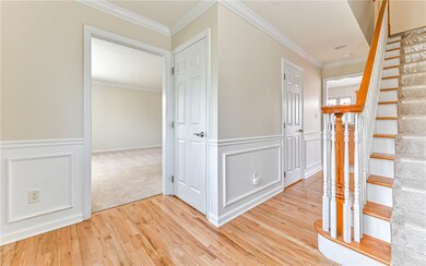 Living Room is left, Half Bath in hallway, Family Room is right (not in this image) and the Kitchen is straight down the hallway.